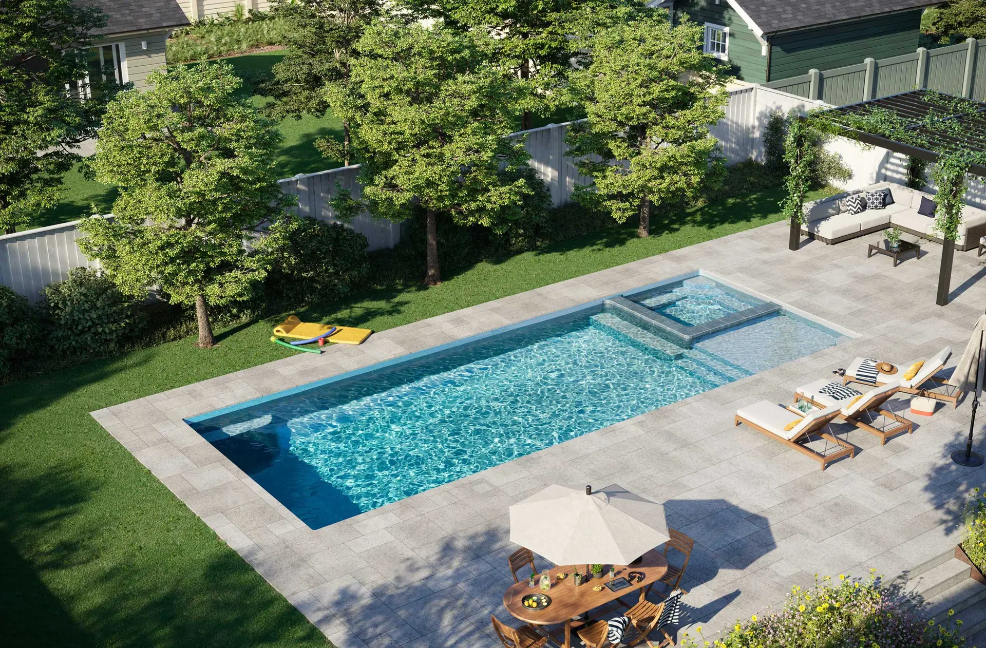 Latham fiberglass pool with a built-in spa and stone decking