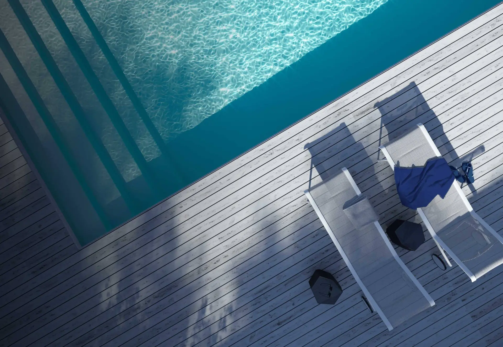 Latham fiberglass pool with an integrated tanning ledge and deck chairs