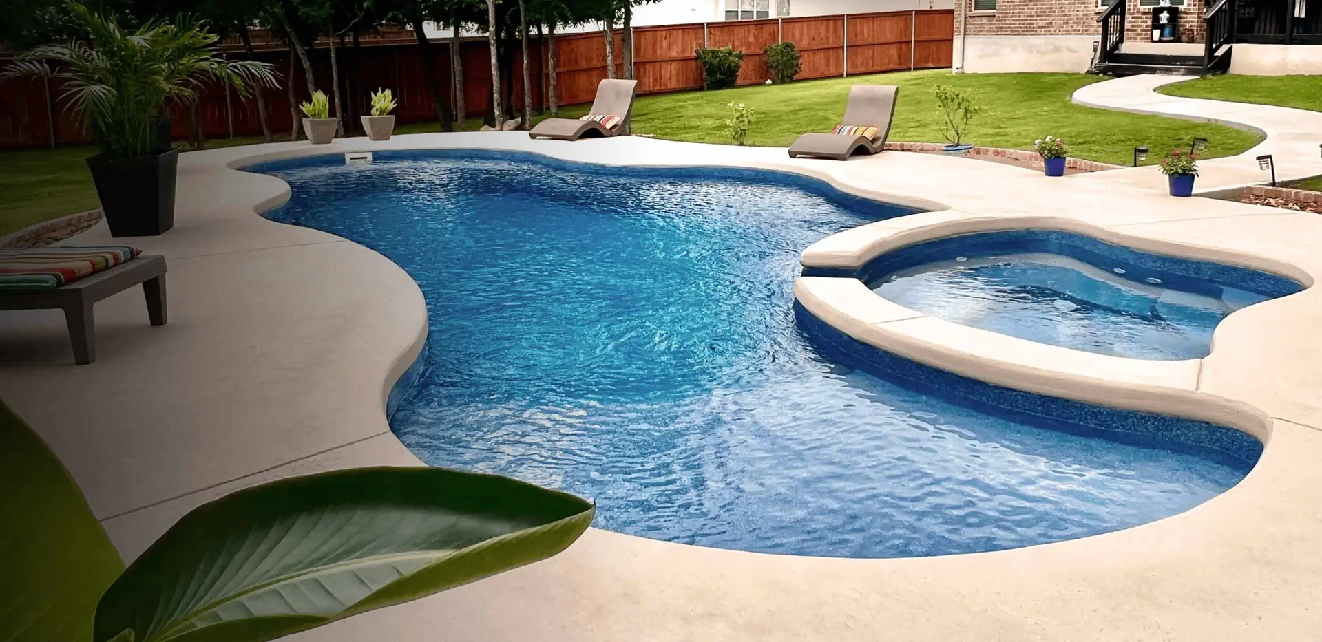 Latham spillover spa cascading into an inground fiberglass pool